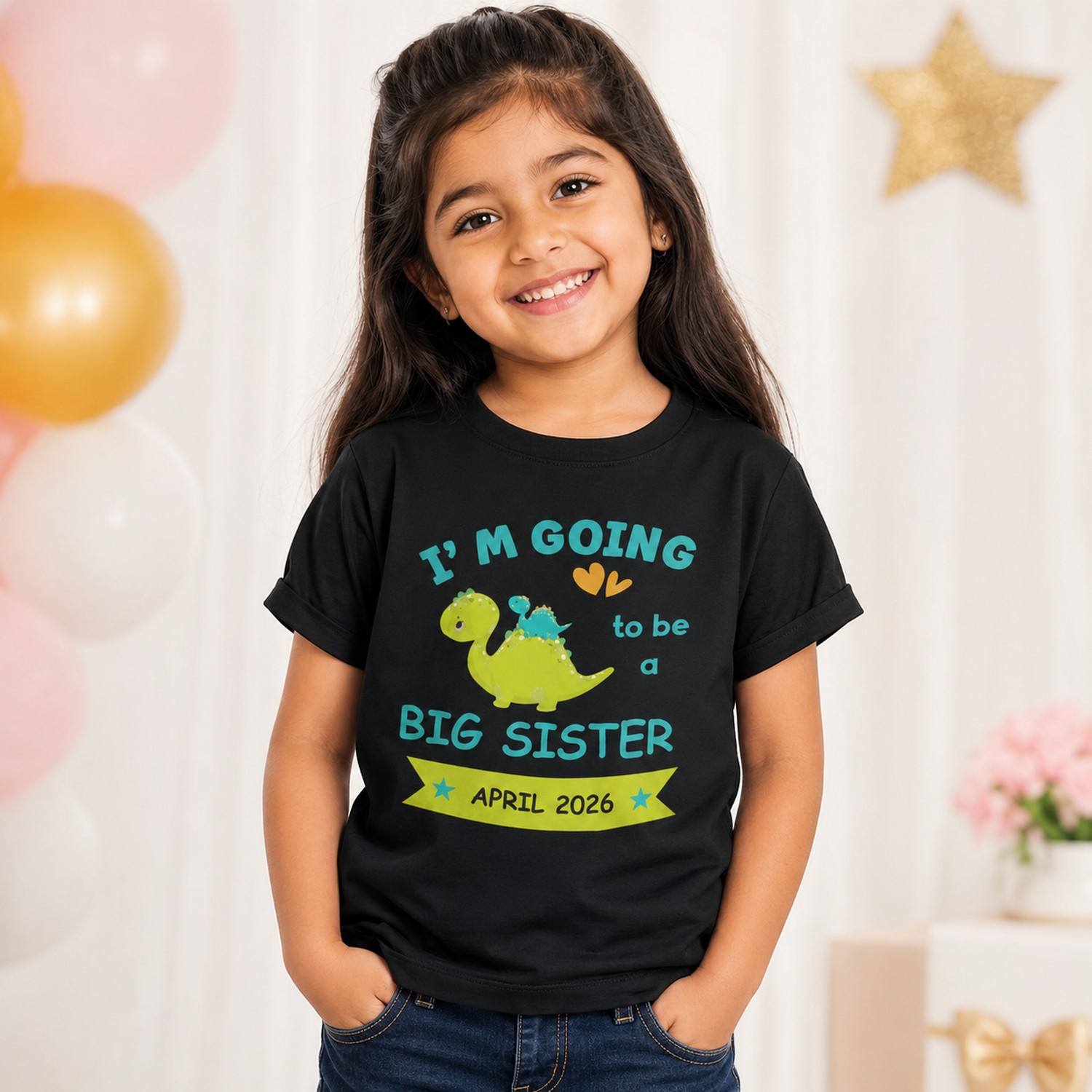 Young girl wearing a black big sister announcement T-shirt with dinosaur design and April 2026 due date text