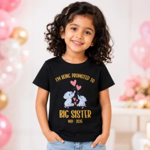 Little girl wearing a black big sister announcement t-shirt with cute elephant design and May 2026 text