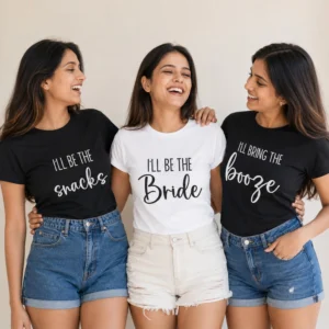 Bride wearing a white I'll Be The Bride T-shirt with friends in black I'll Bring the Snacks and Booze bachelorette shirts