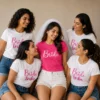 Bride wearing a pink Bride T-shirt and veil with friends in matching white Bride Tribe T-shirts