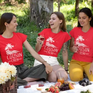 Three women wearing red cousin crew matching t-shirts with tropical design during a picnic outing