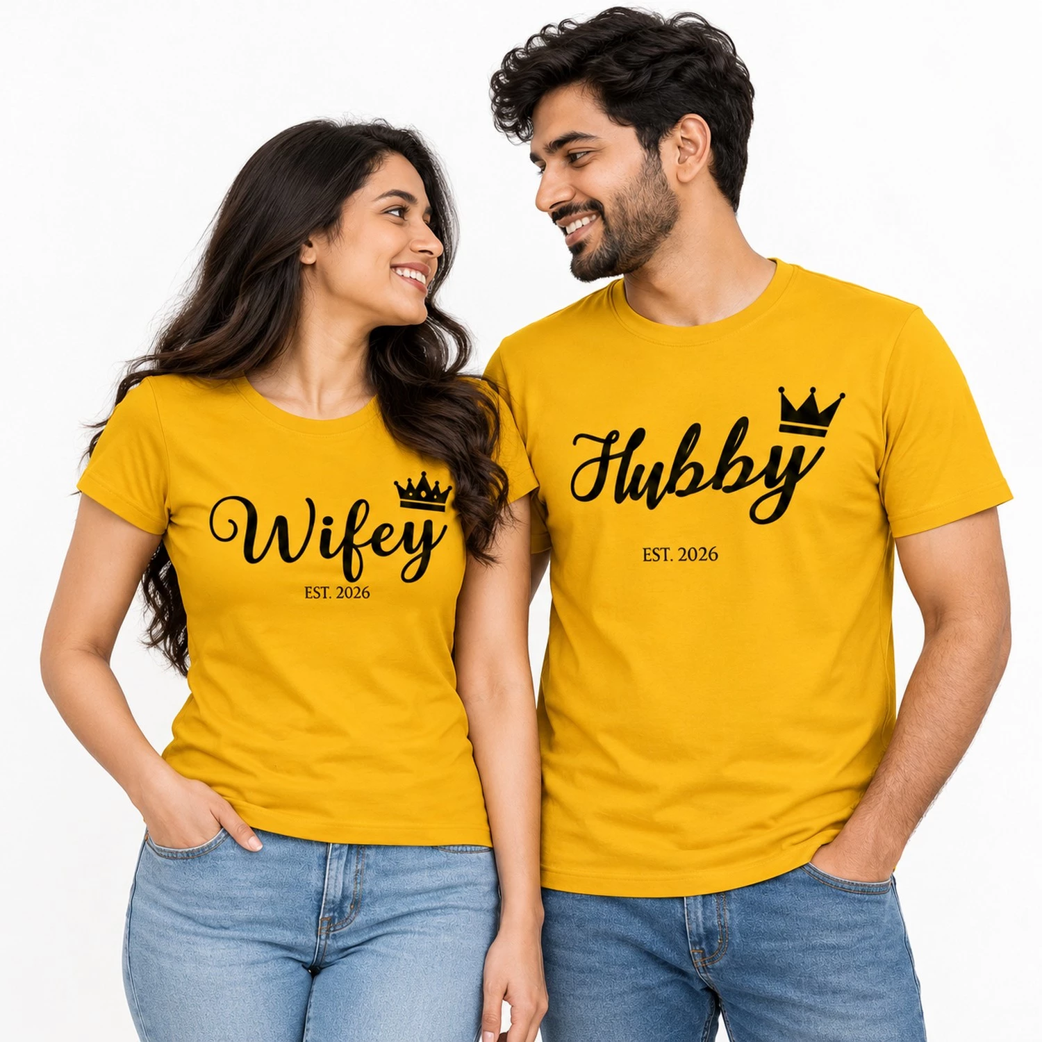 Indian couple wearing matching yellow Hubby and Wifey T-shirts with black cursive lettering, crown graphics, and EST. 2026 prints.