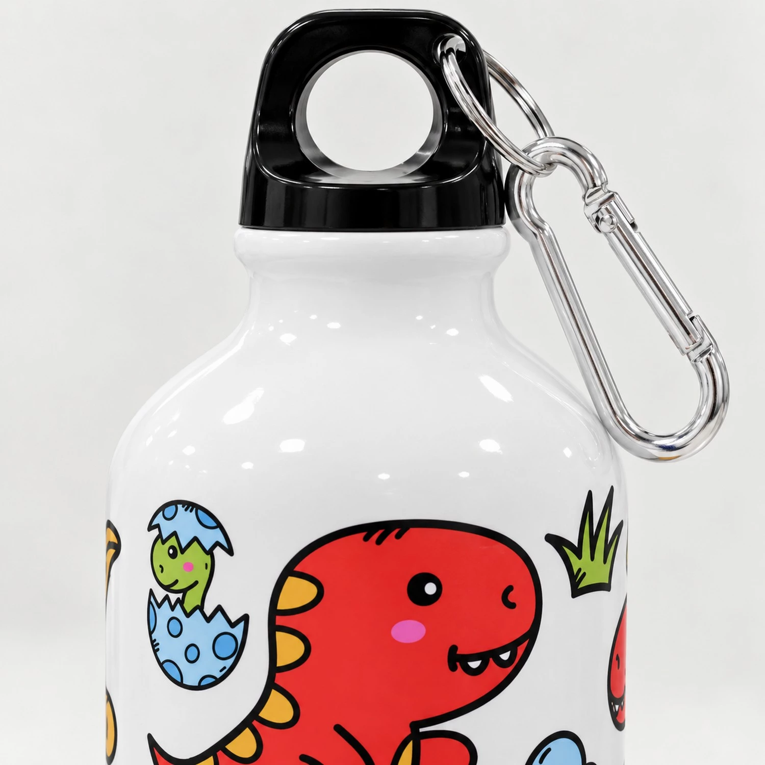 Close-up of a personalized kids aluminum bottle with glossy white neck, black loop cap, silver carabiner clip, and dinosaur print.