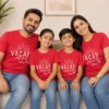 Family wearing matching red Vacay Mode 2026 vacation T-shirts for parents and children with white travel graphic