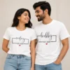 Couple wearing matching white Wifey and Hubby Est. 2026 T-shirts with script lettering and red heart design