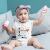 Baby wearing a personalized 9 months milestone onesie with cute bear design and custom name, ideal for baby photoshoot