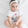 Baby wearing a personalized 6 months milestone onesie with custom name and cute unicorn design