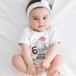 Baby wearing a personalized 6 months milestone onesie with custom name and cute unicorn design