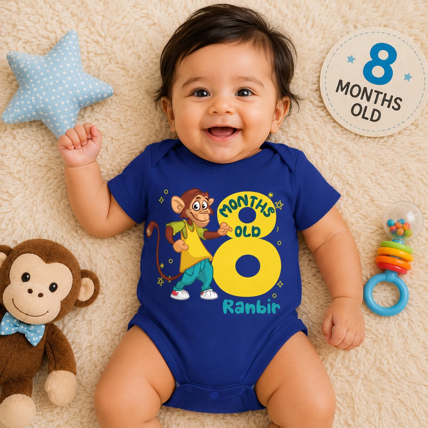 Baby wearing a personalized 8 month milestone blue onesie with cartoon monkey design and custom name printed