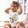 Baby girl wearing a personalized milestone onesie with name and 11 months print featuring a cute fox and rainbow design