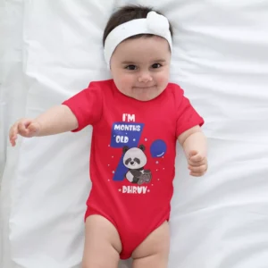 Baby wearing a personalized red milestone onesie with panda design and custom name for monthly photoshoot