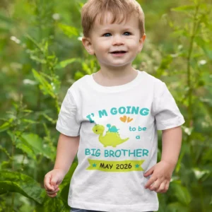 Toddler wearing a personalized big brother announcement T-shirt with cute dinosaur design and due date print outdoors