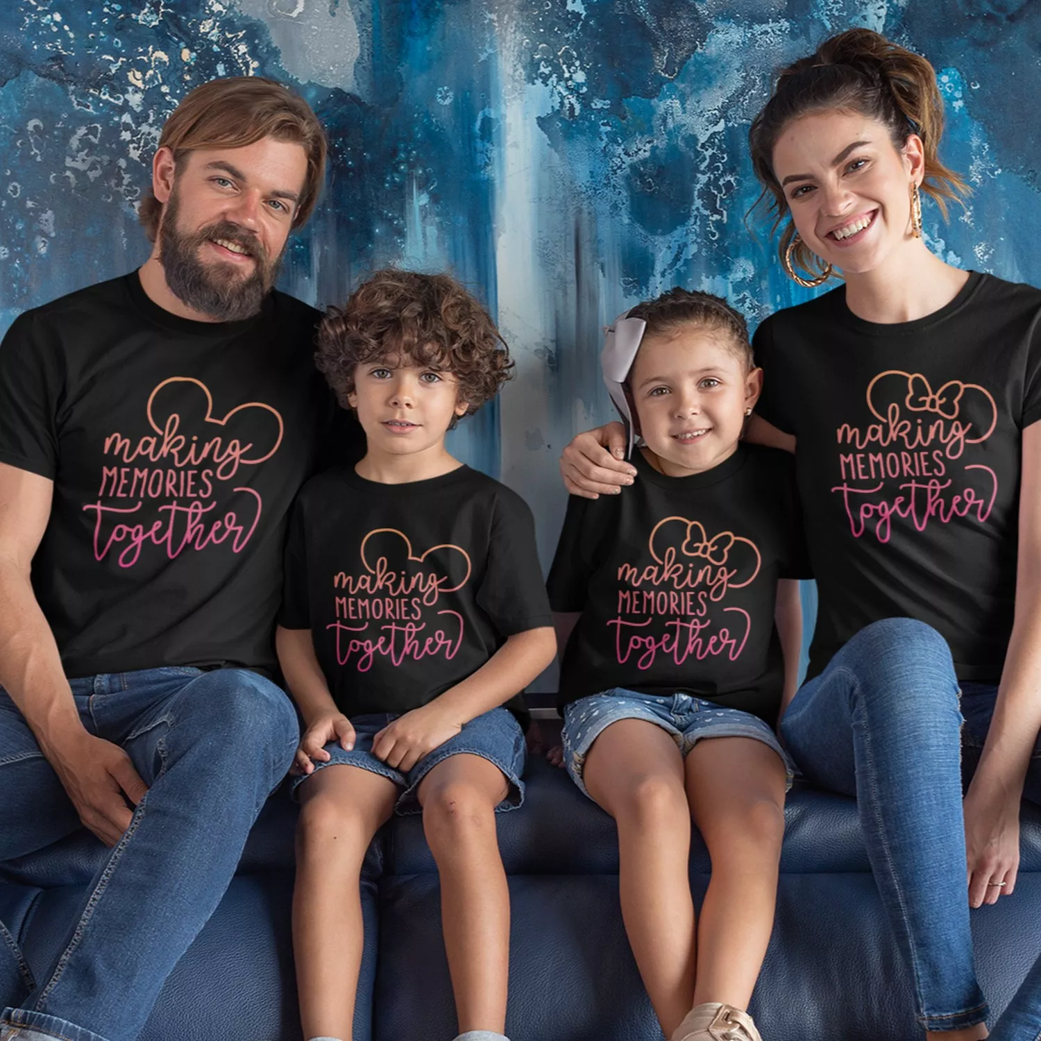 Family of four wearing matching black t-shirts with “Making Memories Together” typography design, ideal for vacations and photoshoots