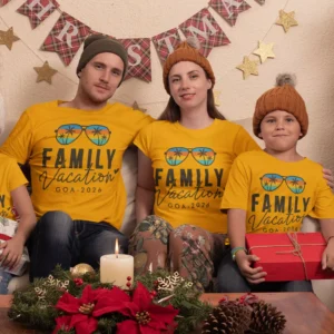 Family wearing matching yellow personalized vacation t-shirts with “Family Vacation Goa 2026” design sitting together during a holiday moment