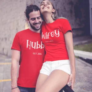 Couple wearing matching red hubby and wifey personalized T-shirts with year printed, ideal for prewedding or anniversary