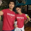 Couple wearing red matching hubby and wifey t-shirts with custom year print, perfect for anniversary or pre-wedding photoshoot