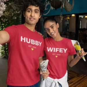 Couple wearing red matching hubby and wifey t-shirts with custom year print, perfect for anniversary or pre-wedding photoshoot