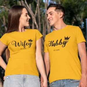 Couple wearing matching yellow Hubby and Wifey T-shirts with custom year print, holding hands outdoors