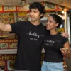 Couple wearing black matching hubby wifey personalized t-shirts with est year at street food stall