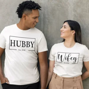 Couple wearing matching personalized hubby and wifey t-shirts with custom est year printed in minimal typography design