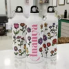 Personalized kids water bottle with colorful floral design and custom name printed, ideal for school and gifting