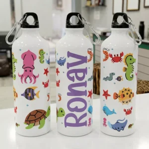 Personalized kids water bottle with custom name and colorful ocean animal illustrations including fish, turtle, and crab design