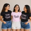 Bride wearing a pink Bride T-shirt with friends in matching black Team Bride T-shirts with diamond graphics