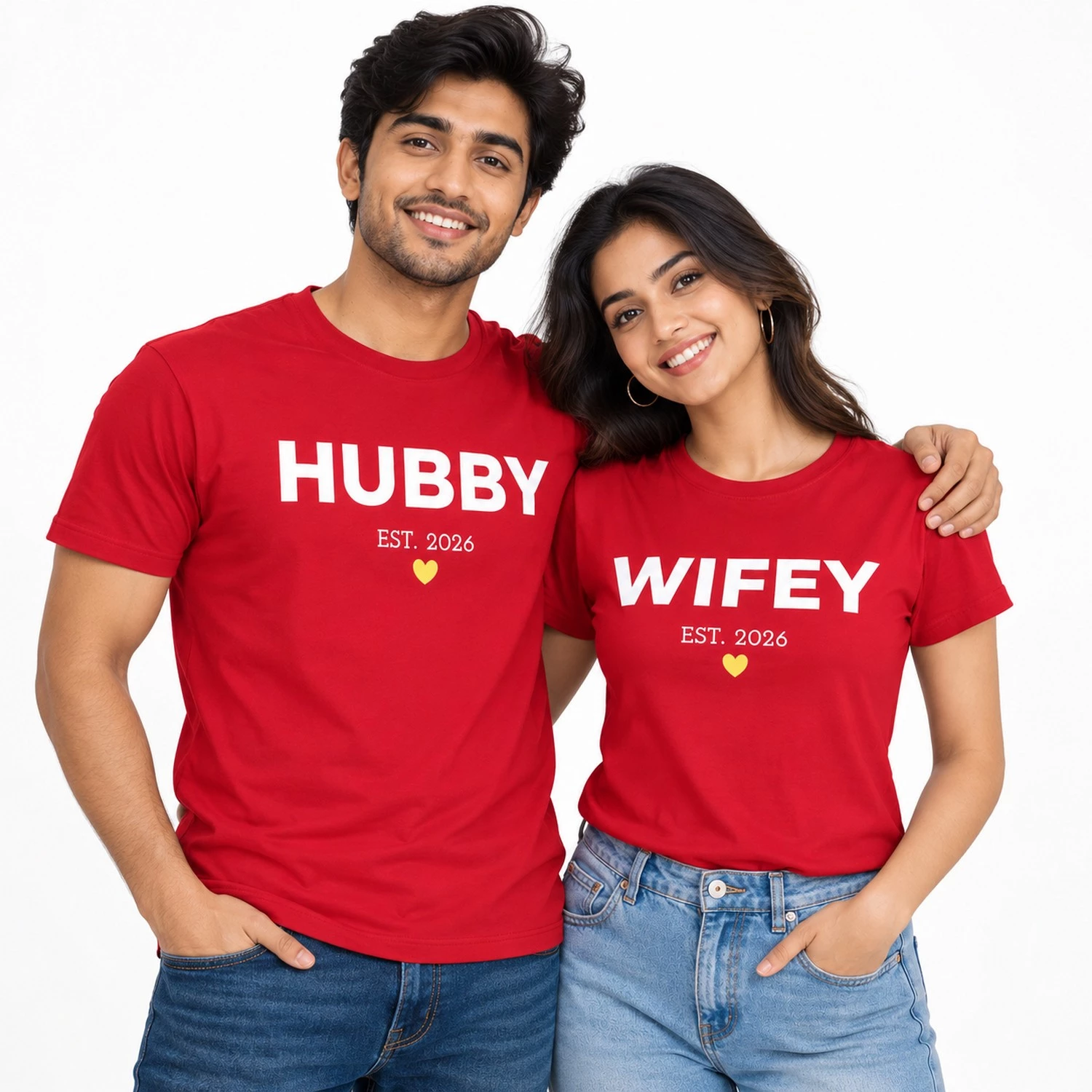 Indian couple wearing matching red HUBBY and WIFEY T-shirts with bold white uppercase lettering, EST. 2026 text, and small yellow heart symbols.