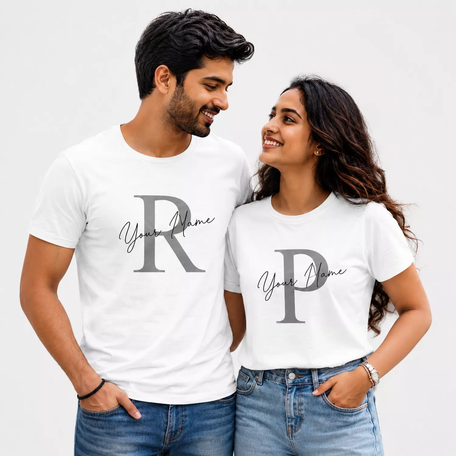 Couple wearing matching white personalized initial T-shirts with custom name and monogram designs, suitable as a custom gift for couples.