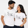 Couple wearing matching white personalized T-shirts with initials, names, and established year design, suitable for anniversary gifting.