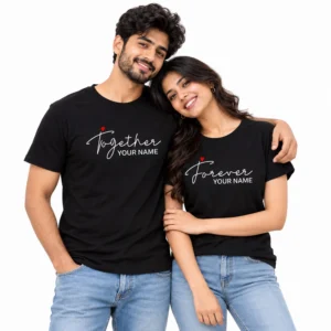 Indian couple wearing matching black personalized couple T-shirts with white Together and Forever script designs, red heart accents, and custom name placeholders on the front.