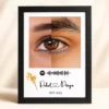 Personalized couple eye photo frame with custom names, song code, dried flower design, and EST 2024 text in a black frame.