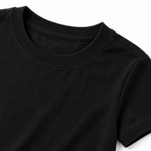 Close-up of a black kids t-shirt showing cotton fabric texture, ribbed crew neckline, shoulder stitching, and sleeve finishing.