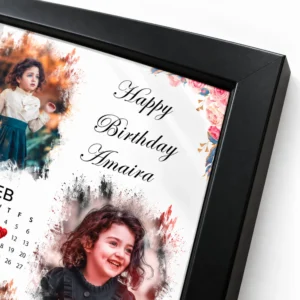 Close-up of the black corner and edge of a personalized baby birthday photo frame with floral artwork and custom name Amaira.
