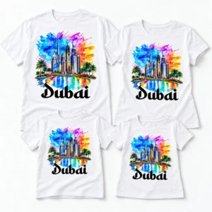 Four matching white Dubai family vacation T-shirts arranged in a flat lay, featuring colorful skyline prints in adult and kids' sizes.