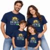 Family vacation T-shirts worn by two adults and two children in navy blue with a Dubai skyline graphic and DUBAI Mode ON print on a clean studio background.