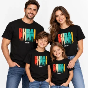 Family vacation T-shirts with matching black Dubai 2026 skyline prints worn by two adults and two children on a light studio background.