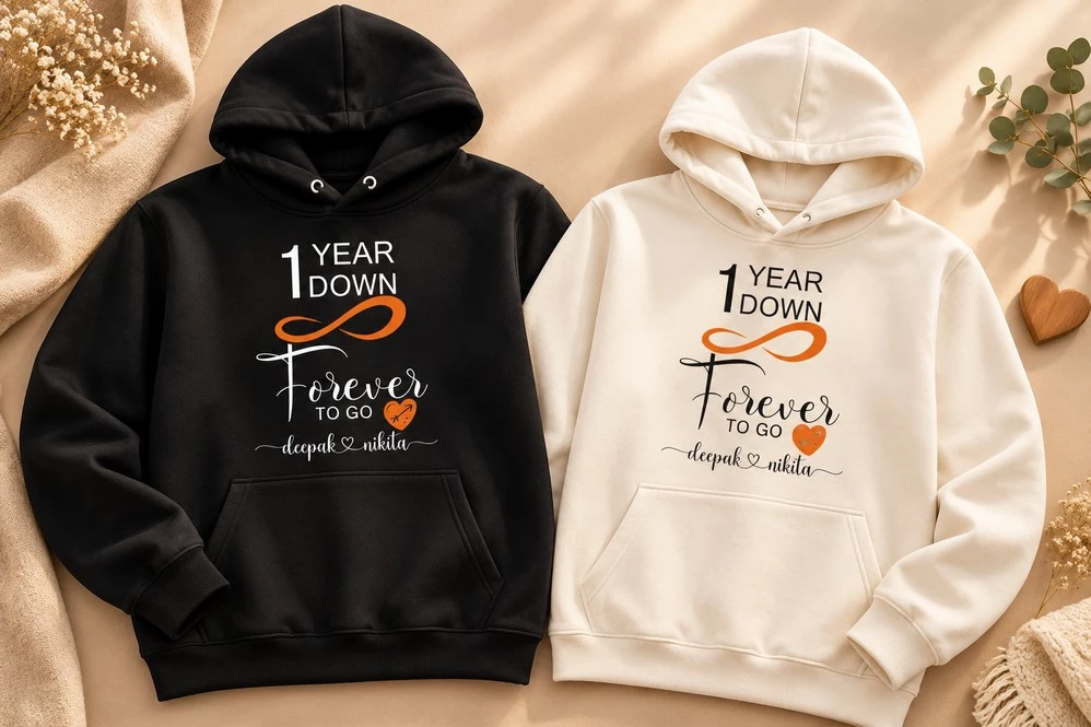 Black and white matching couple hoodies featuring a 1 Year Down Forever to Go anniversary design with personalized names.