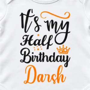 Close-up of the personalized half birthday baby romper print with “It’s my Half Birthday Darsh” lettering, orange stars and crown.