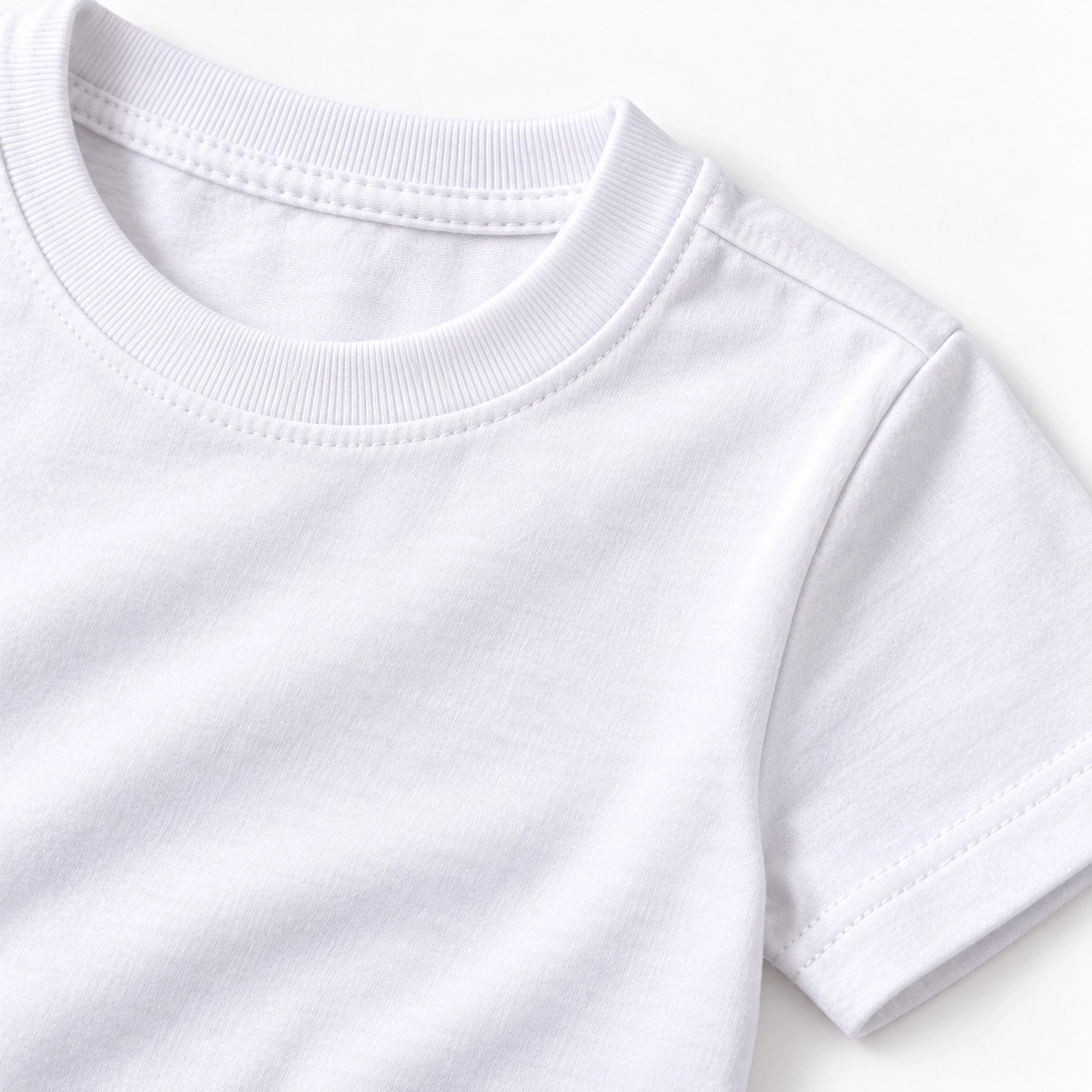 Close-up of white kids t-shirt fabric, ribbed crew neckline, shoulder seam, and sleeve stitching detail