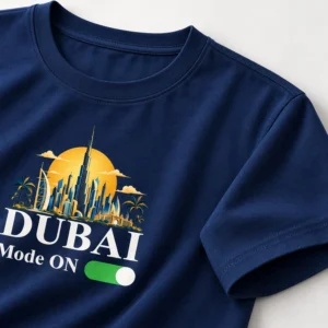 Detailed product view of a navy blue Dubai T-shirt showing cotton texture, crew neck, sleeve stitching, and part of the Dubai Mode ON print.