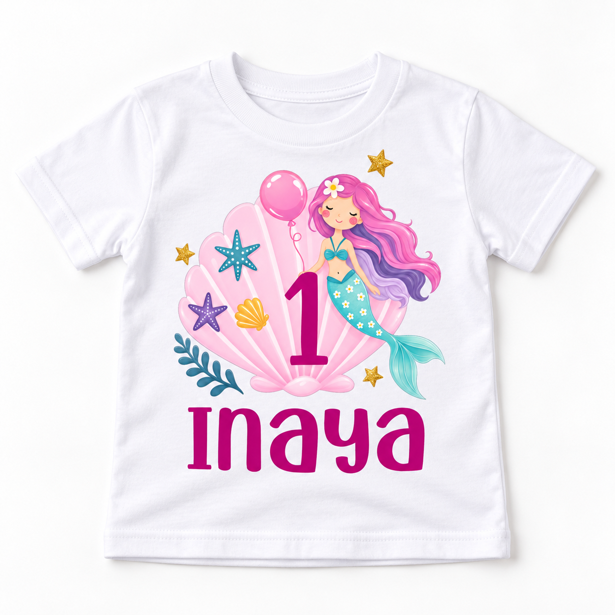White personalized 1st birthday kids t-shirt flat lay with mermaid birthday print, pink number 1, and the name Inaya