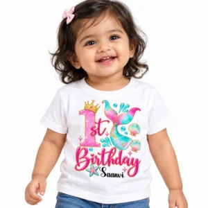 Toddler wearing a white personalized 1st birthday kids t-shirt with a pink and turquoise mermaid birthday design and the name Saanvi