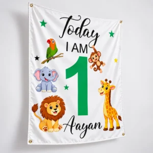 Three-quarter view of personalized birthday tapestry with Aayan name, green number 1, jungle animals, soft white fabric, and metal grommets.