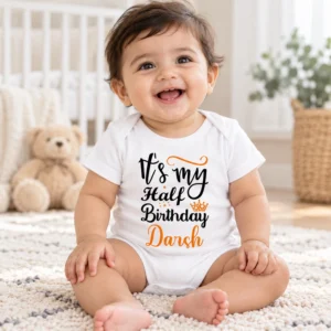 Happy baby wearing a white personalized half birthday baby romper with Darsh name while sitting in a bright neutral nursery.