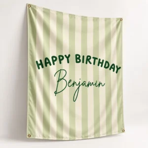 Three-quarter view of a personalized kids birthday tapestry banner with sage and cream stripes, Benjamin name, Happy Birthday design, and corner grommets.
