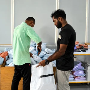 Team scanning and preparing customer parcels for dispatch at Printgen's production house.